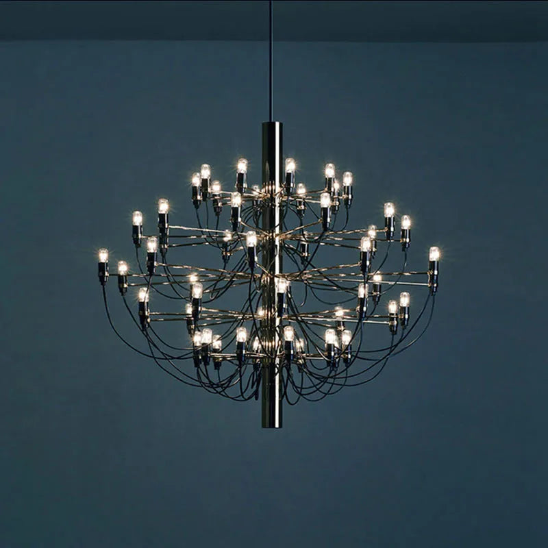 Modern wooden three-prong floor lamp with an acrylic shade in a living room setting.