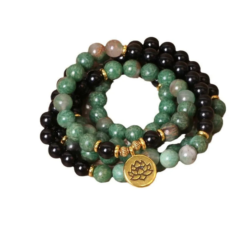 Green and black alloy elastic beaded bracelet with natural styling on wrist