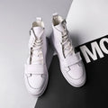 Men's black PU leather ankle boot with high-top sneaker design on a white background