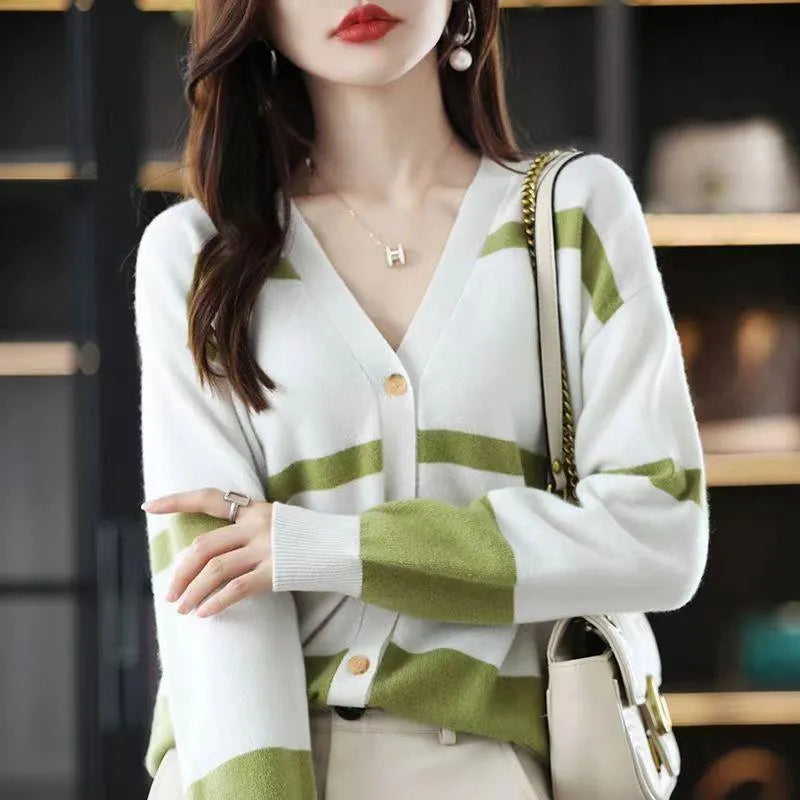Women's striped V-neck knitted cardigan buttoned up, showcasing its slim fit and 3D pattern texture.