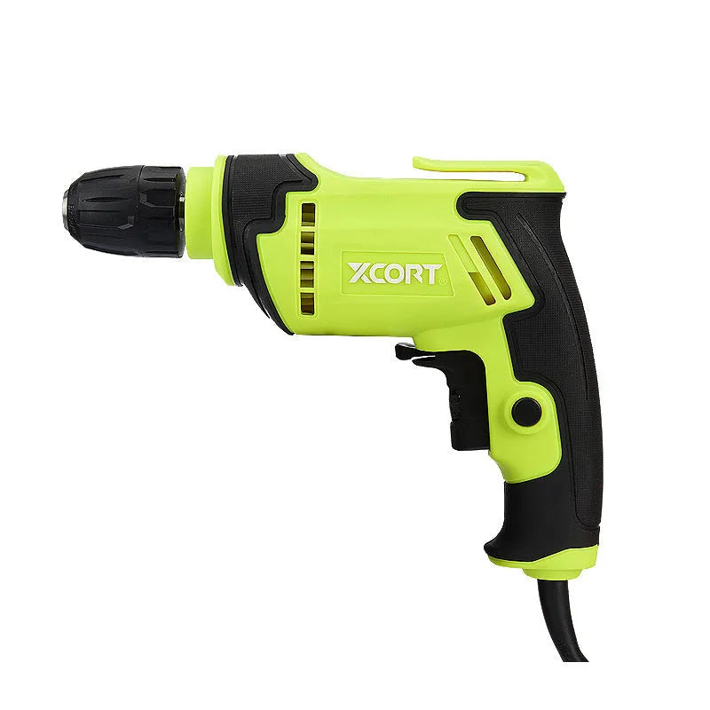 Pistol-grip electric power drill with a black and orange casing on a workbench.