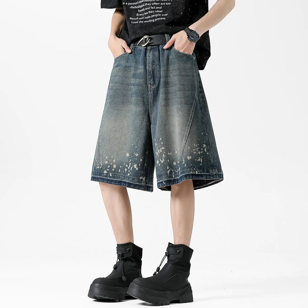 Men's retro blue denim shorts with ripped details, splash ink design, and five-point star decorations on a straight-leg cut.