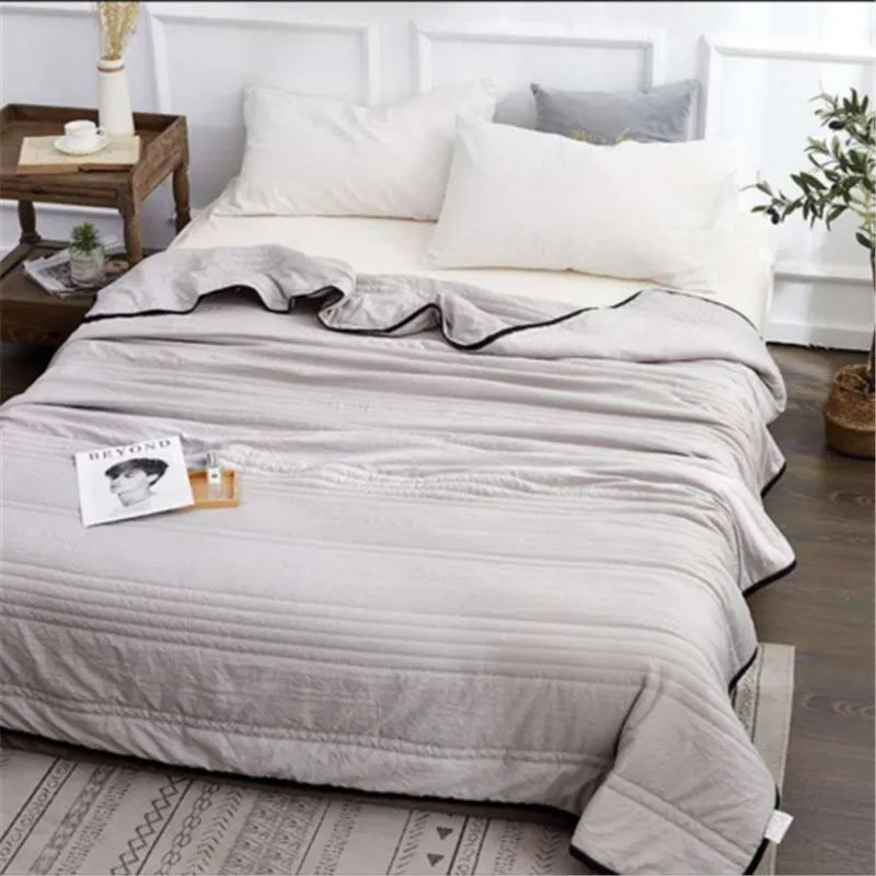 Pure colour seersucker cooling air-conditioning quilt laid flat on a bed