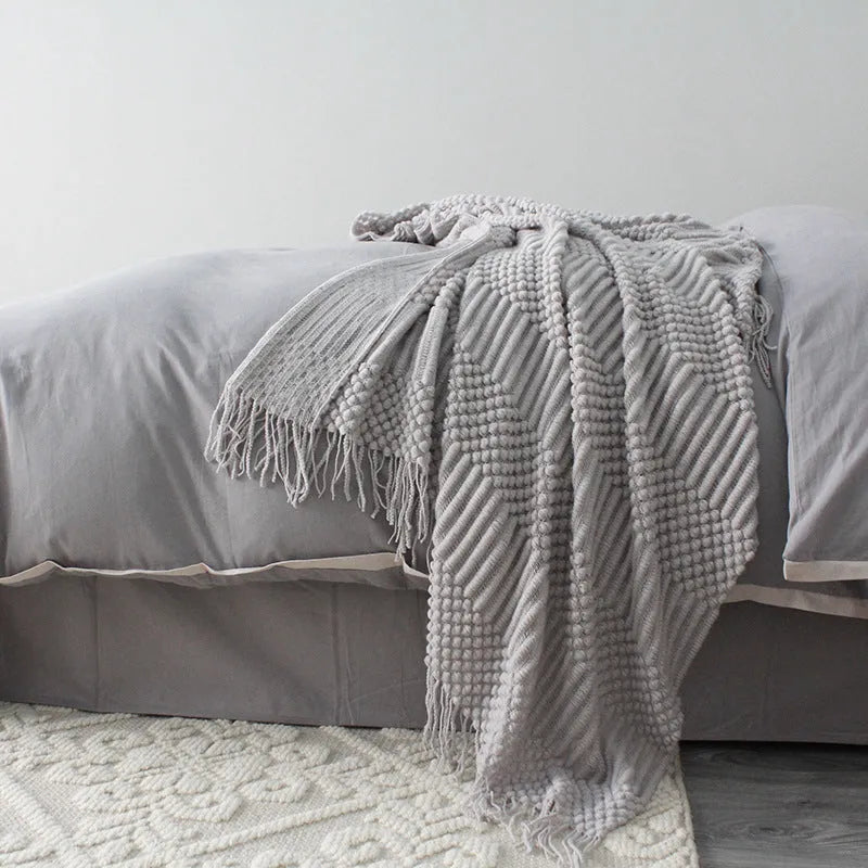 Small light grey polyester nap blanket folded, showing its texture and 127x170 cm size.