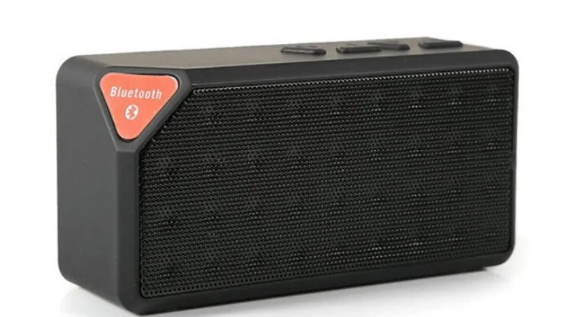 Cannon X3 small cube-shaped wireless Bluetooth portable speaker in five colour options on a table.