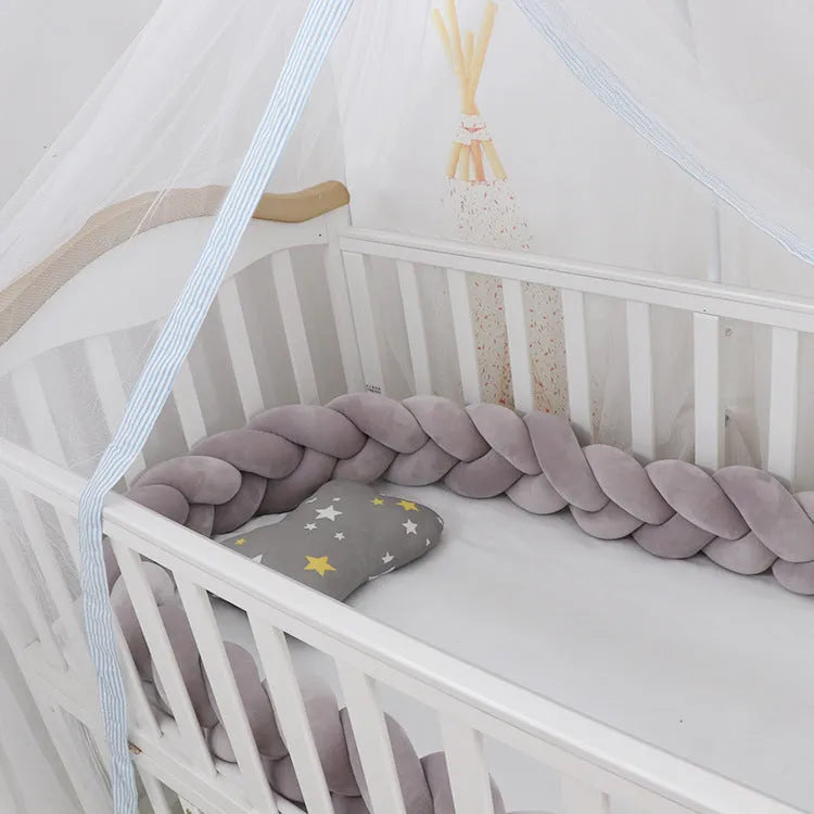 Spandex velvet crib bumper in a light grey colour, bent to show its flexible shape.