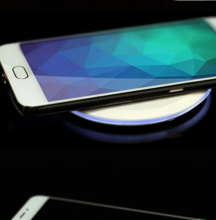 Ultra-thin wireless charger for mobile phone, black, with USB cable, showing charging indicator light
