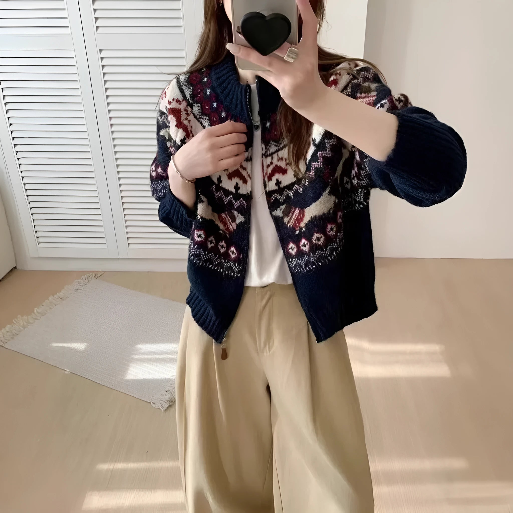 Beige ethnic Jacquard pattern pullover sweater with 3D effect and round neck on a hanger.