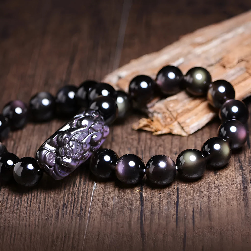 Polished crystal Pi Xiu bracelet with geometric ice stone beads on a wrist.