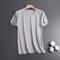 Man wearing a grey ice silk mesh short sleeve crew neck t-shirt with a loose fit.