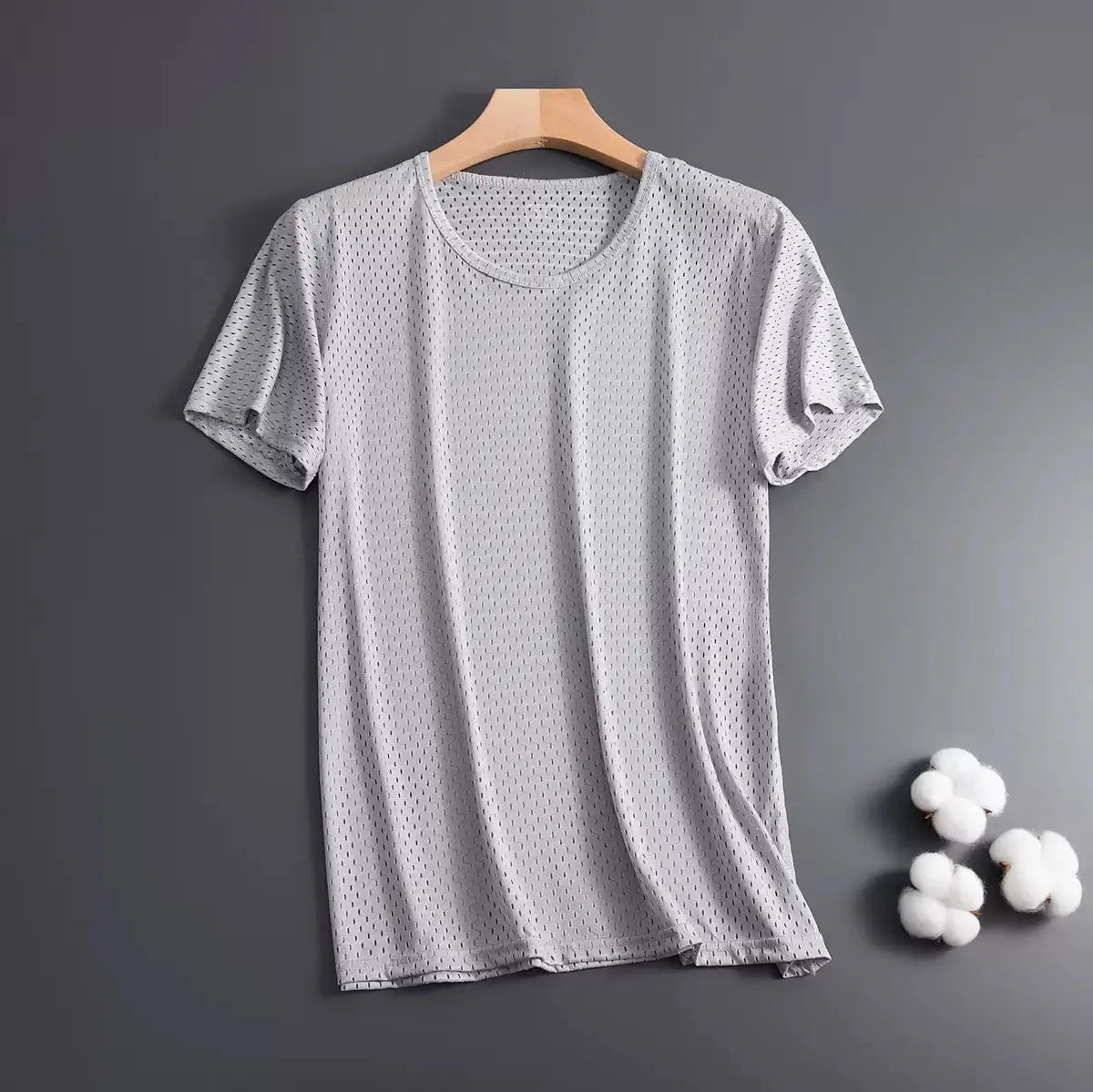 Man wearing a grey ice silk mesh short sleeve crew neck t-shirt with a loose fit.