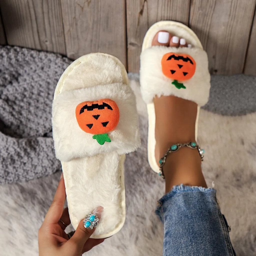 Yellow Halloween pumpkin cartoon design plush slippers with synthetic fur and a light-coloured sole.