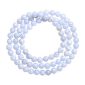 Natural blue agate bracelet showing scattered beads with blue striped pattern and three-circle design