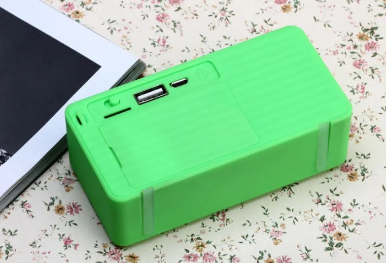 Cannon X3 small cube-shaped wireless Bluetooth portable speaker in five colour options on a table.