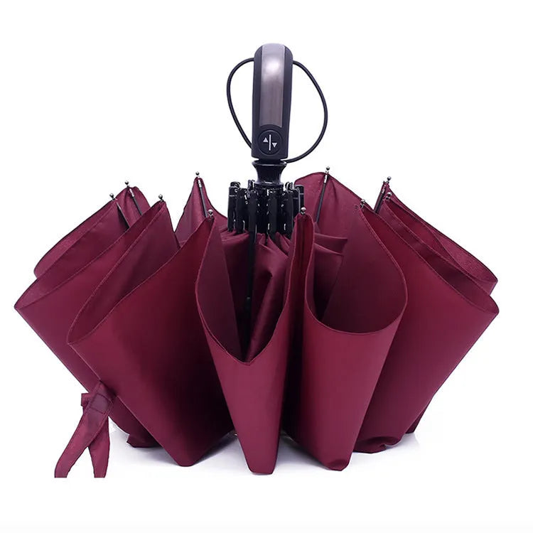 Black triple-folding automatic umbrella open, showing classic palace-style canopy shape.