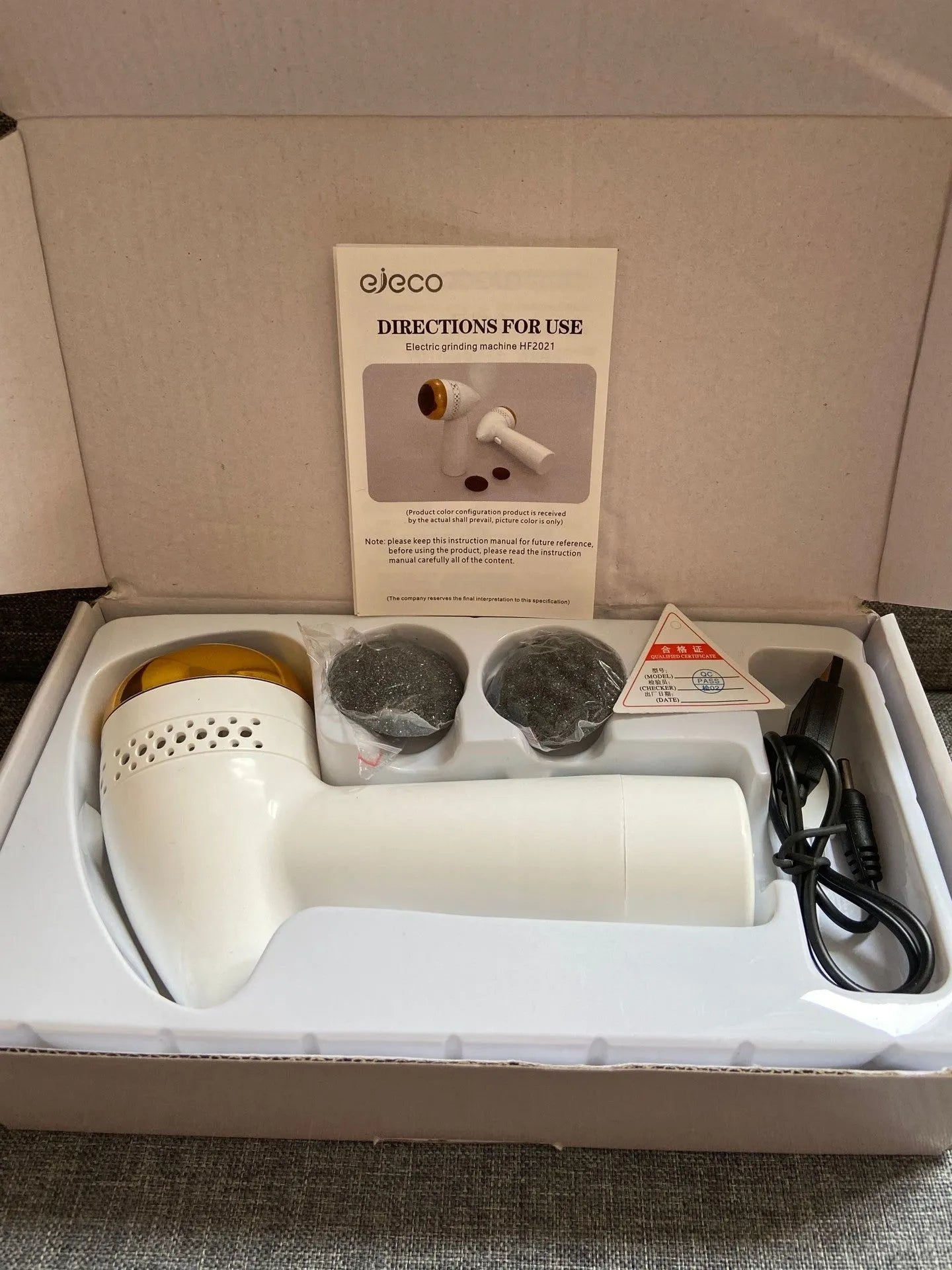 Electric vacuum foot grinder with natural quartz grinding head in gold colour.