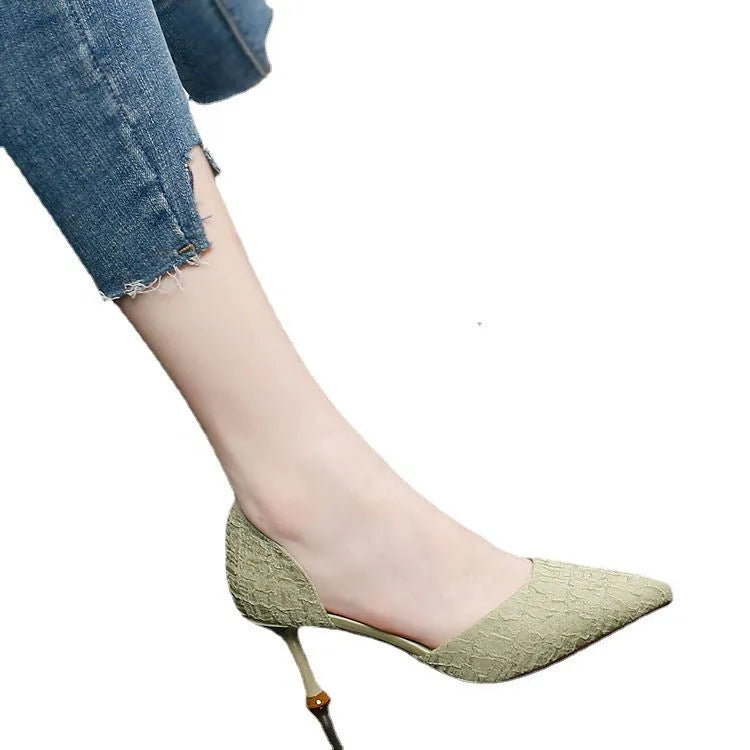 Black pointed toe stiletto high heel shoe on a white background.