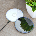 Black wireless charging pad with LED indicator light on aluminium alloy surface