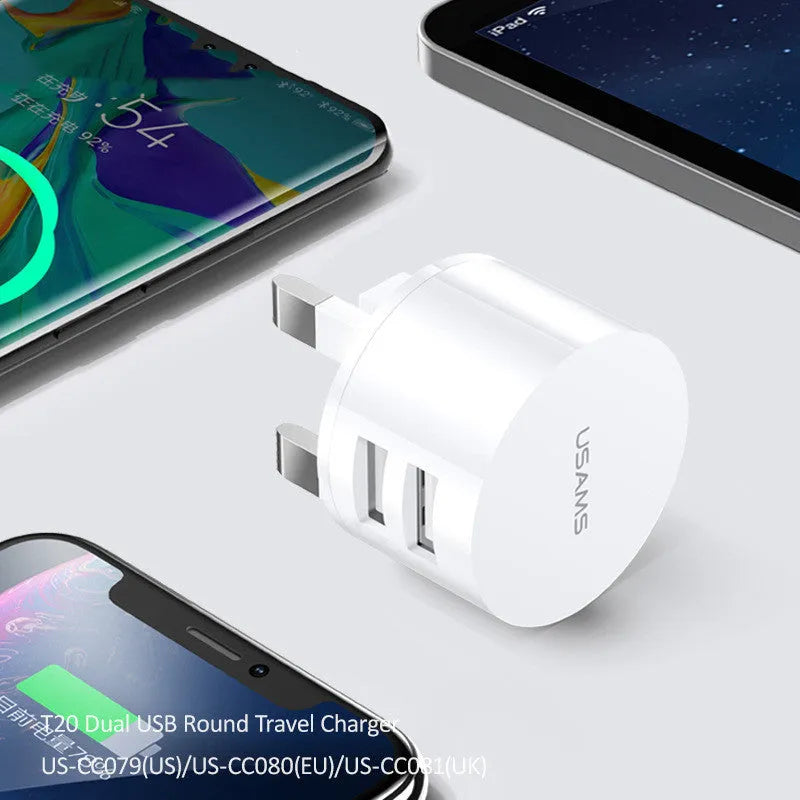 White universal USB phone charger with foldable US, UK, and EU plugs showing compact design