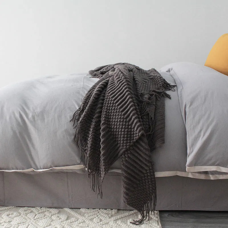 Small light grey polyester nap blanket folded, showing its texture and 127x170 cm size.