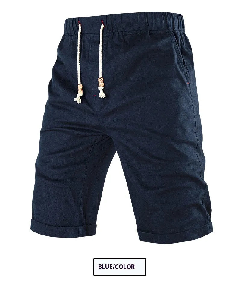Man wearing grey cotton blend straight leg sports shorts with a drawstring waist and a zipper side pocket.