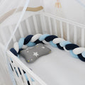 Spandex velvet crib bumper in a light grey colour, bent to show its flexible shape.