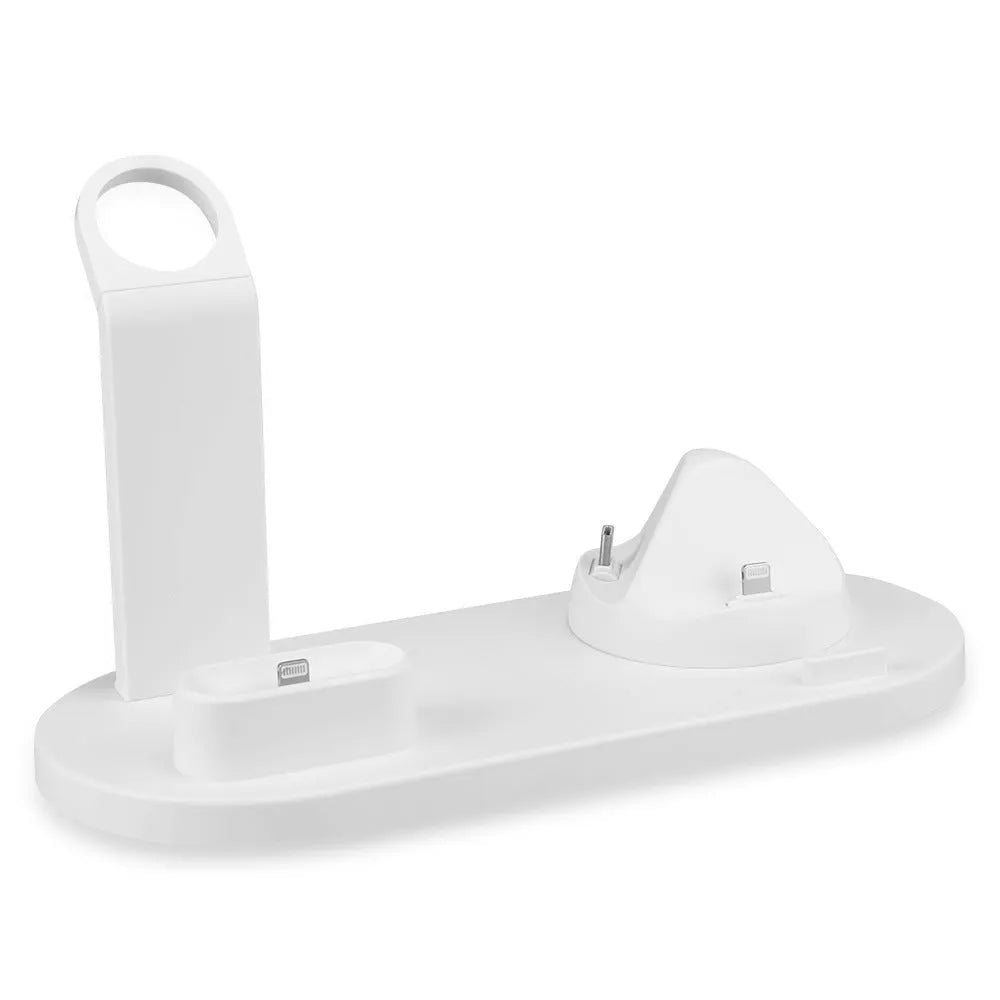 White three-in-one headphone charging stand dock on a desk with a USB cable.