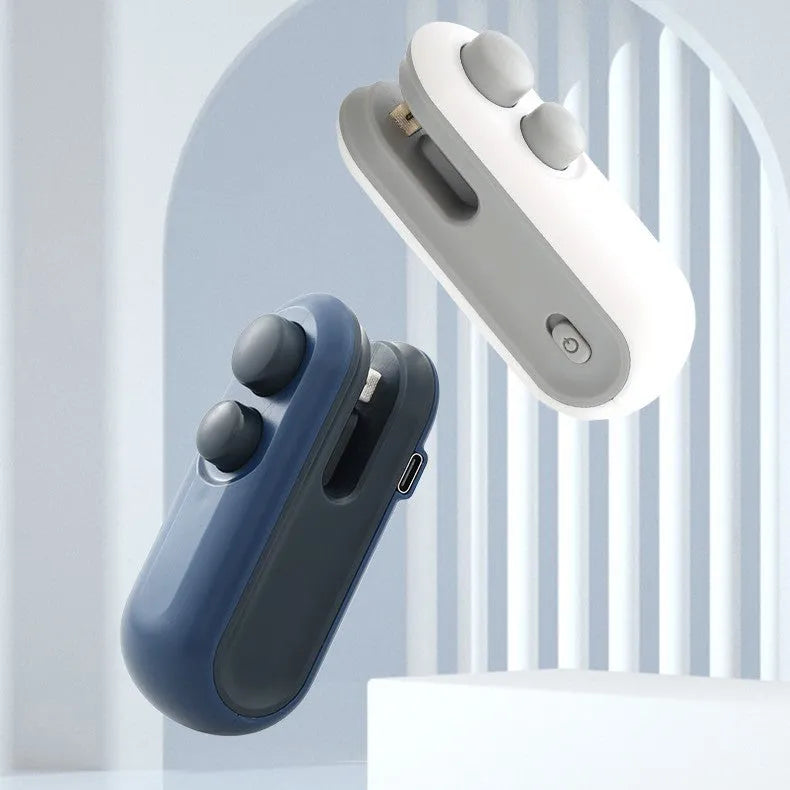 White and blue handheld USB rechargeable bag heat sealer with cutter blade on a kitchen counter.