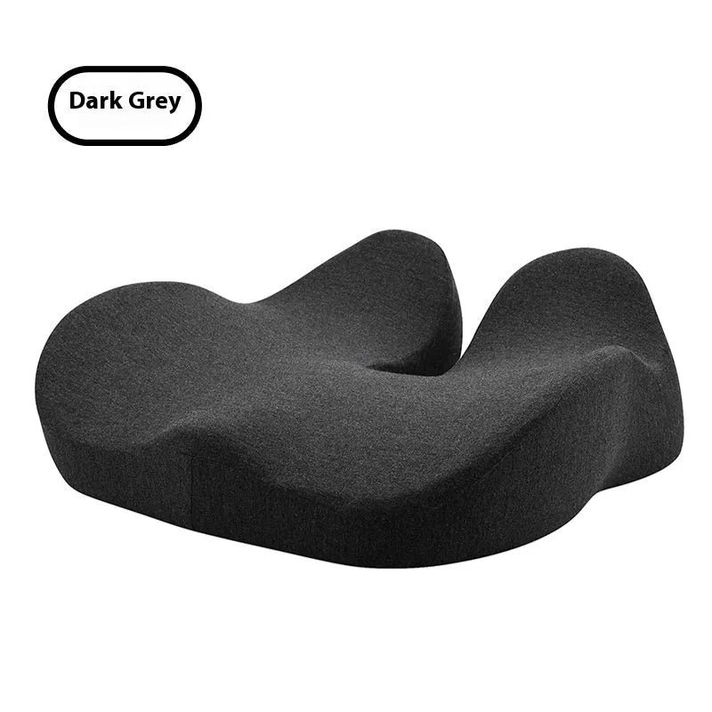 Light grey memory foam office chair cushion showing its thickness on a desk chair.
