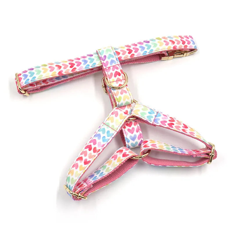 Pink dog harness with gold buckle and colourful heart-shaped stone decoration