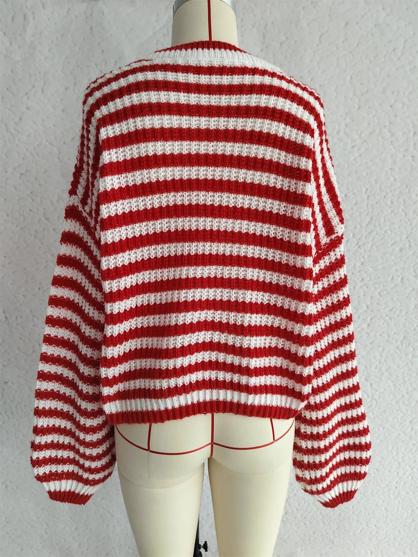 Women's loose vintage stripe knit pullover sweater in a choice of four colours on a hanger.