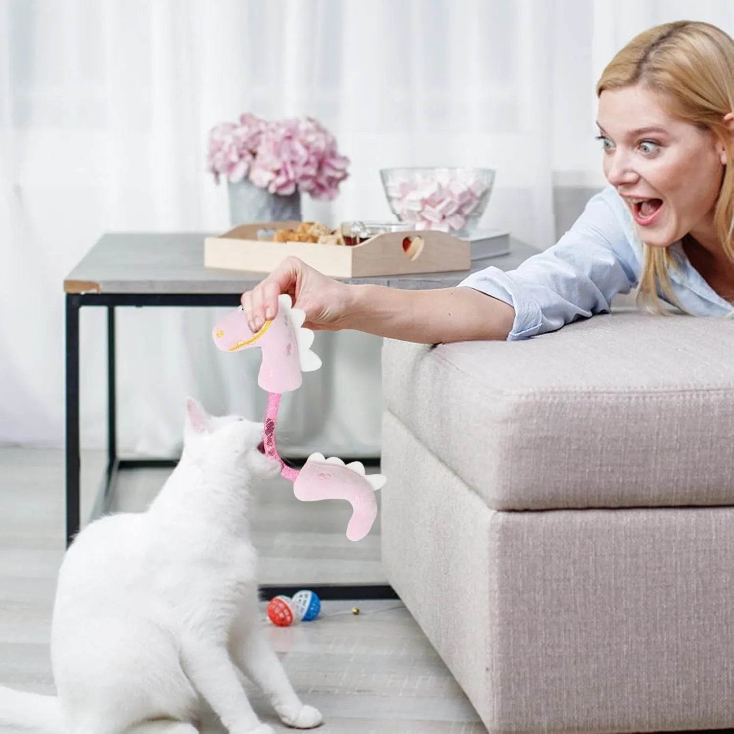 Four cat toys: chew toy, catnip rope, springs, and kicker toy in pink, purple, or yellow colours, each 23cm by 6cm.
