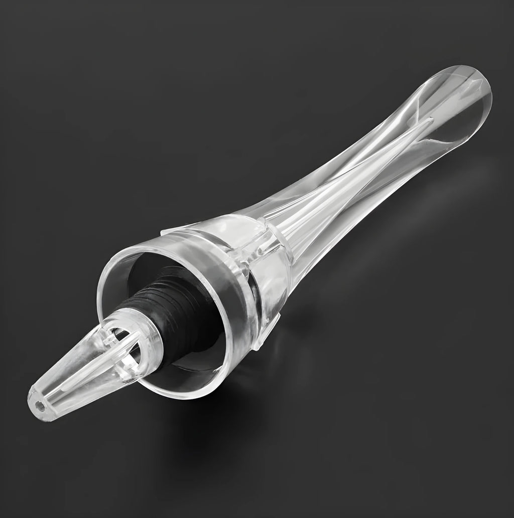 Clear acrylic wine aerator with stainless steel filter, shown next to a wine glass.
