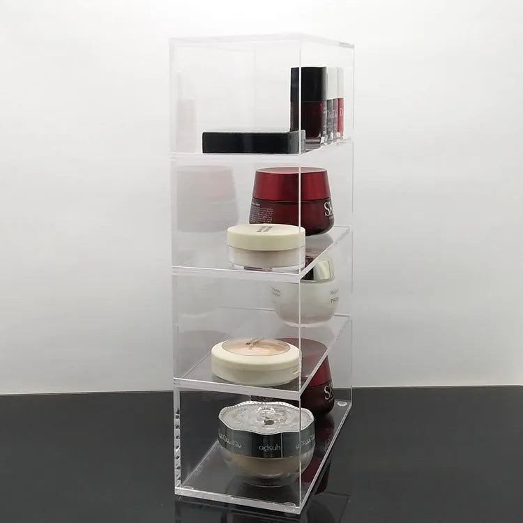 Clear acrylic cosmetics storage box 24x10x34cm on a vanity table holding makeup and skincare products