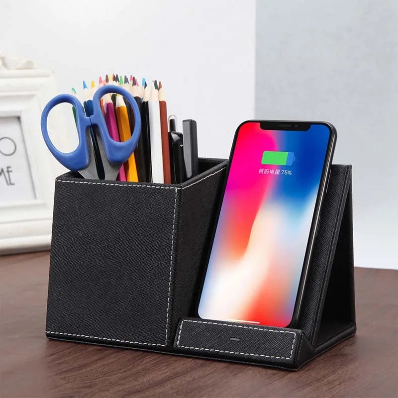 Black leather pen holder with integrated wireless phone charging pad on a desk