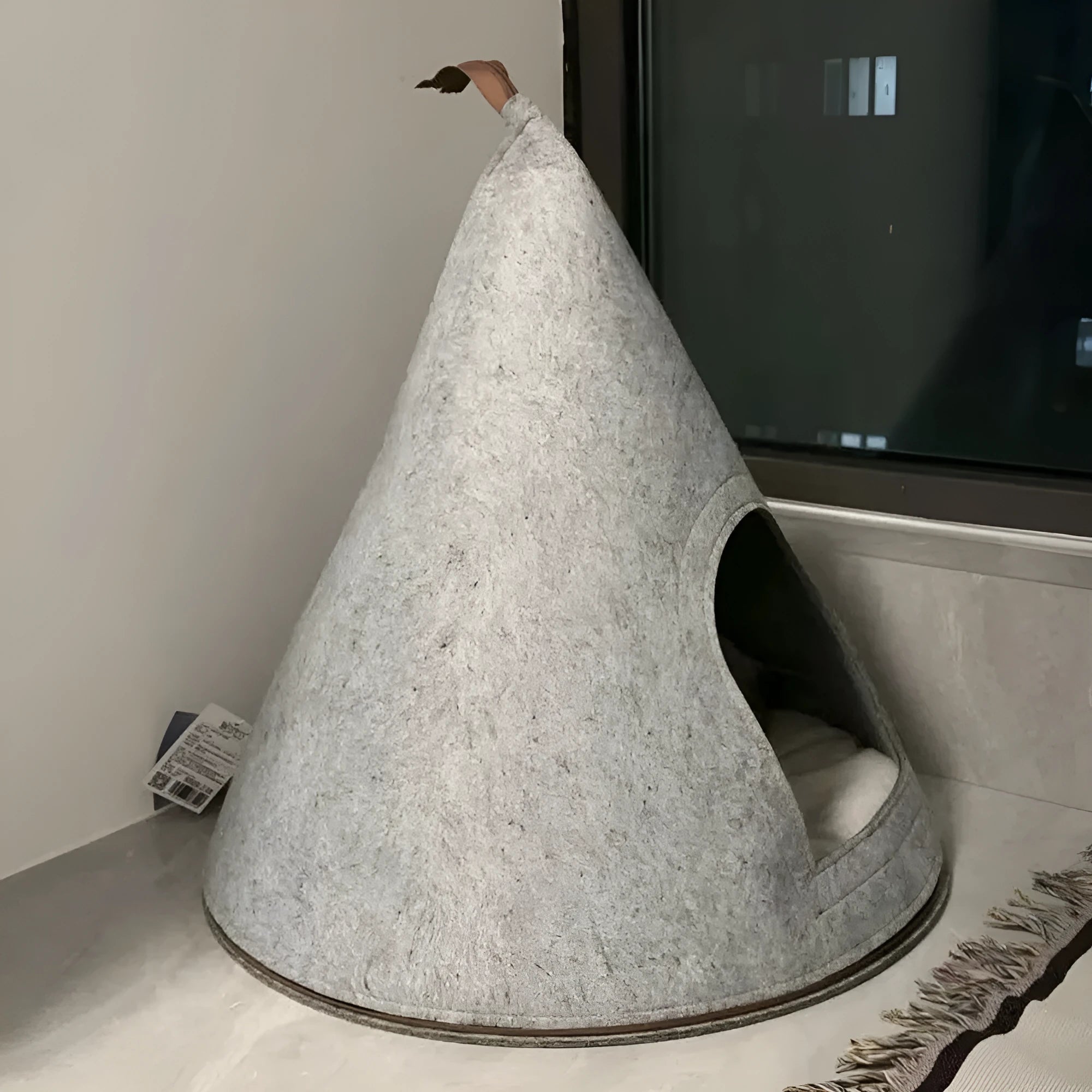 Grey conical felt cat house tent with circular base for indoor use