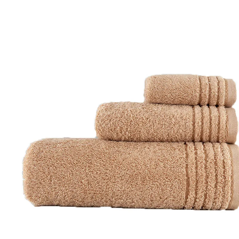 Beige and brown cotton bath towel set showing large bath towel, hand towel, and small face cloth.