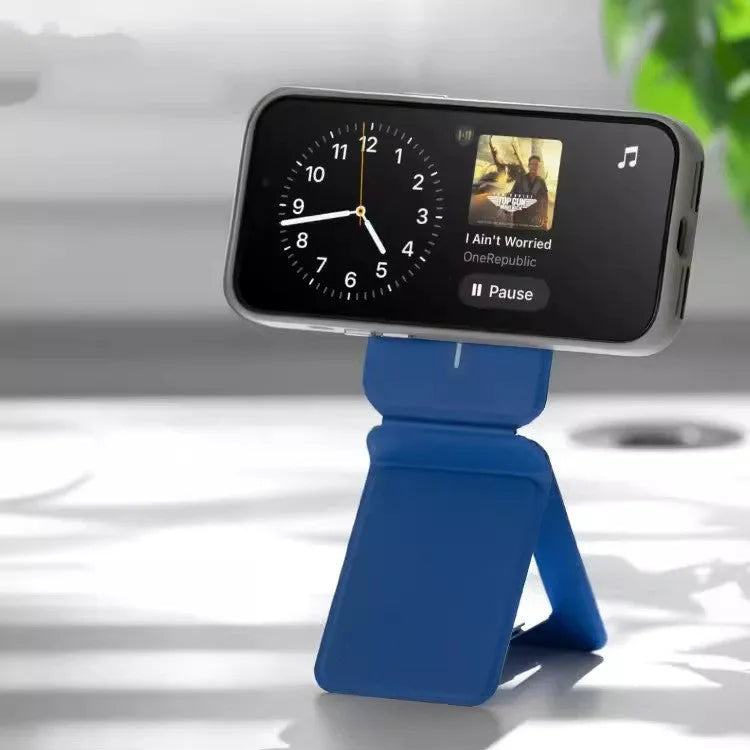Black magnetic mobile phone holder case on a car dashboard, showing compact size and magnetic plate.