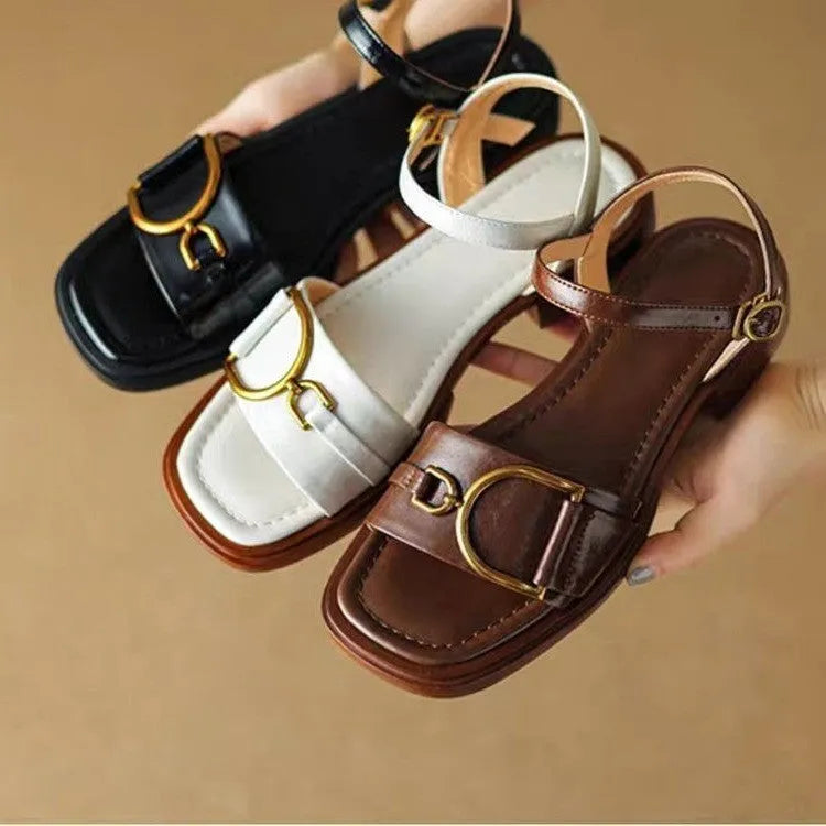 Women's beige leather sandals with a thick rubber sole and a single button closure on the strap.
