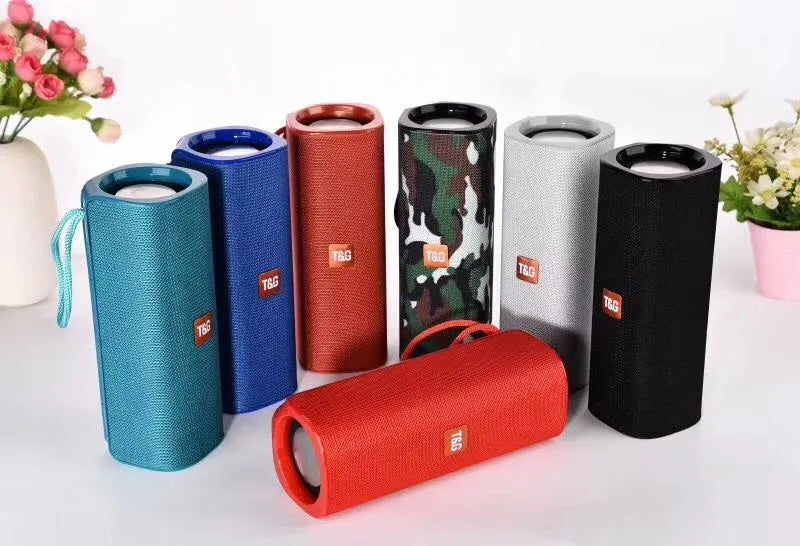 Wireless Bluetooth speaker with cloth cover in multiple colours showing front speaker grille and control buttons