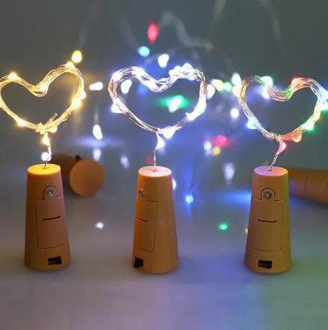 Copper wire LED string lights inserted into wine bottle with warm white illumination