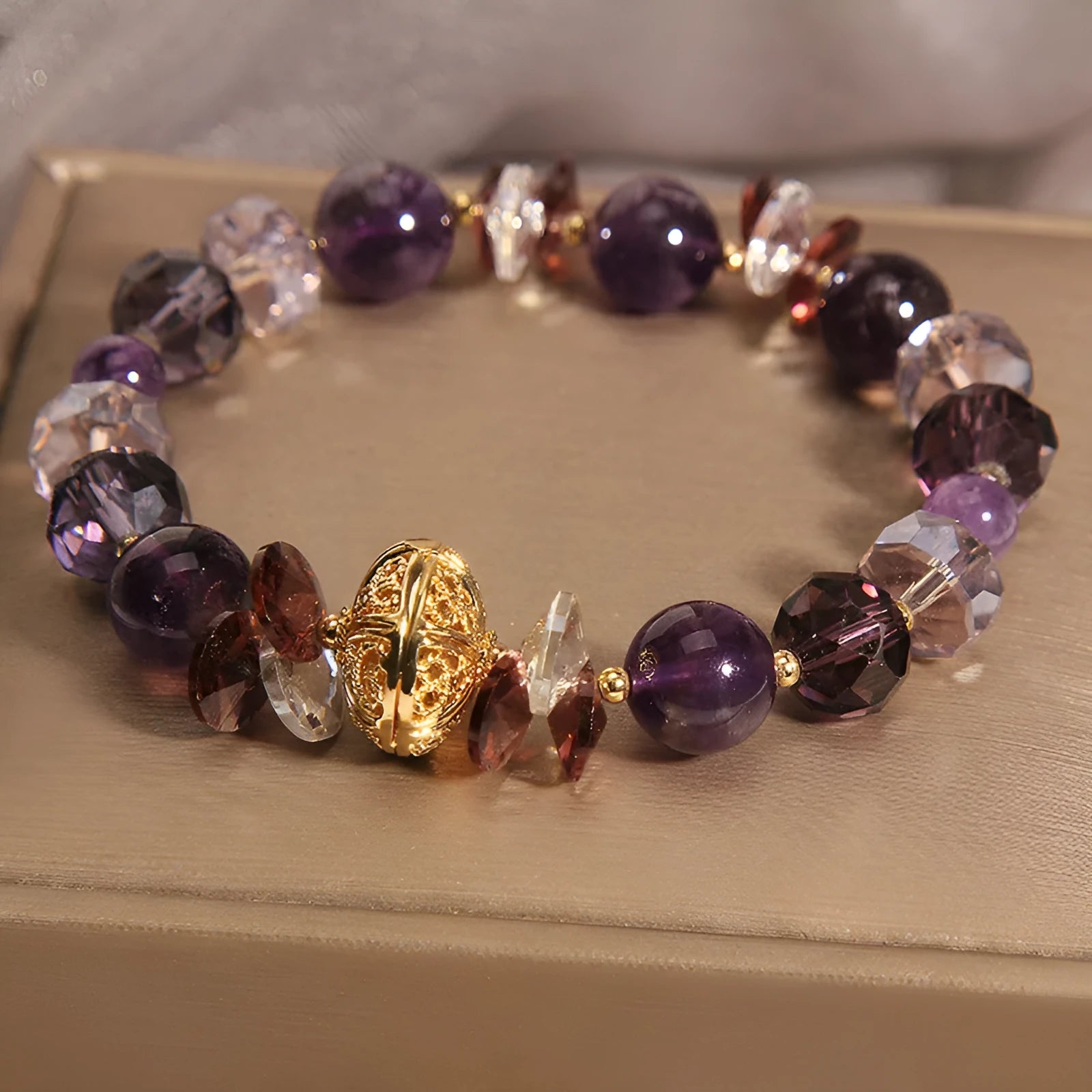 Purple crystal bracelet with pumpkin beads and rhinestone detailing on adjustable band