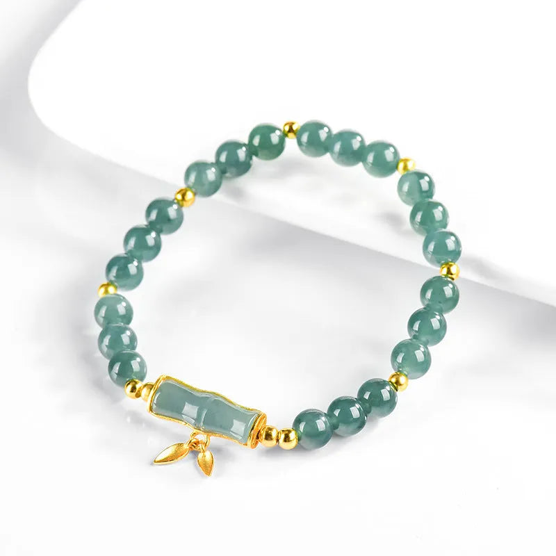 S925 silver bracelet with natural A cargo jade and blue round beads on a wrist.
