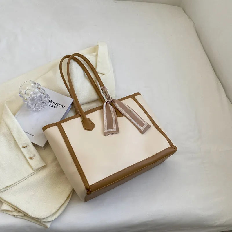 Soft PU leather square tote shoulder bag in black showing open outer pocket and internal phone compartment.