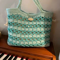 Handwoven wool bag with a summer floral pattern, shown in one of seven available styles.