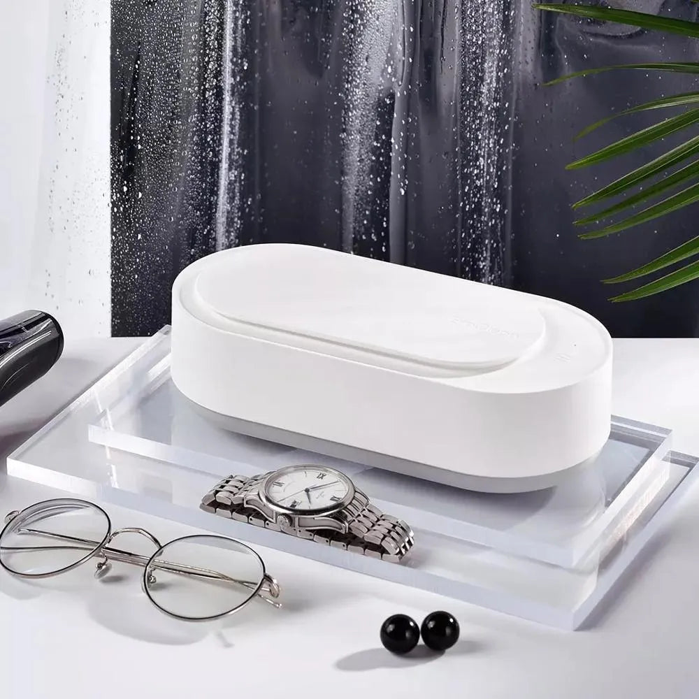 White portable ultrasonic cleaner with stainless steel tank and touch button.