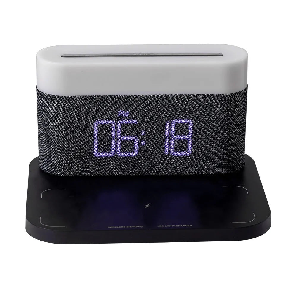 White bedside table lamp with integrated digital clock and wireless phone charging pad on base.