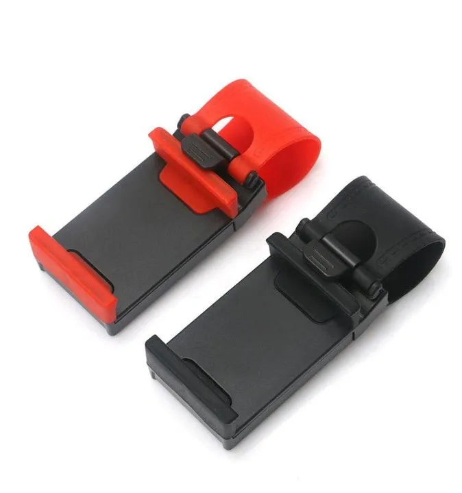 Black universal steering wheel phone holder clip mounted on a car steering wheel holding a smartphone.