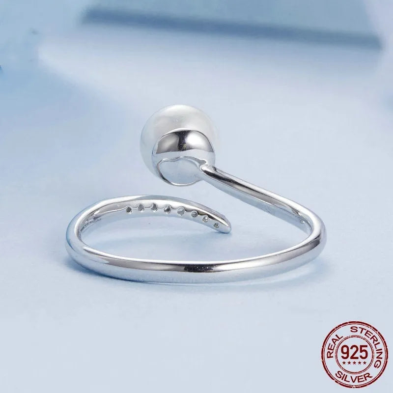 Adjustable S925 sterling silver ring with a pearl on an open-loop band.