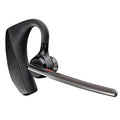 Black wireless sports headphones with a large battery and built-in microphone on a plain background.